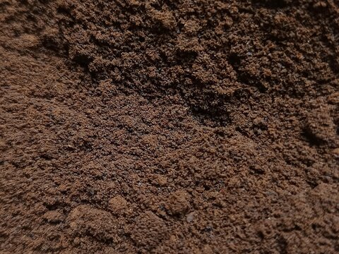 Close up full frame background texture of finely ground coffee powder