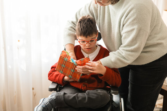 Child with cerebral palsy opening christmas present