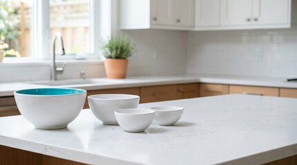 Fototapeta premium Set of White Ceramic Bowls on a White Quartz Countertop in a Modern Kitchen with Copy Space, Bright Daylight