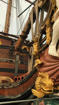 Scenic view of the historic pirate ship replica Galleon Neptune moored along the waterfront harbor with docked boats and yachts in Porto Antico of Genoa, Liguria, northwestern Italy.

