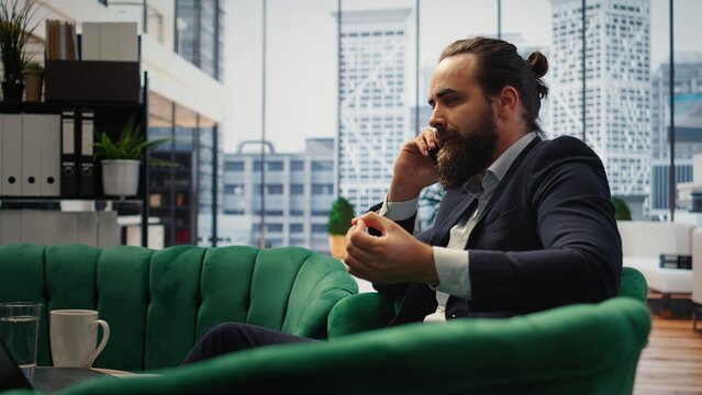 Irritated leader scolds an assistant during a phone call
