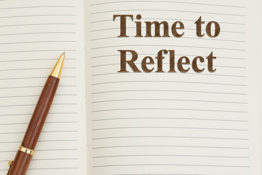 Time to reflect text on writing journal with a pen for journaling for self-care