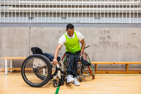 Male para athlete preparing for wheelchair basketball