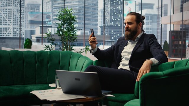Proud director congratulates his team on a video call after efficient work for a successful enterprise while showing good leadership skills and satisfaction.