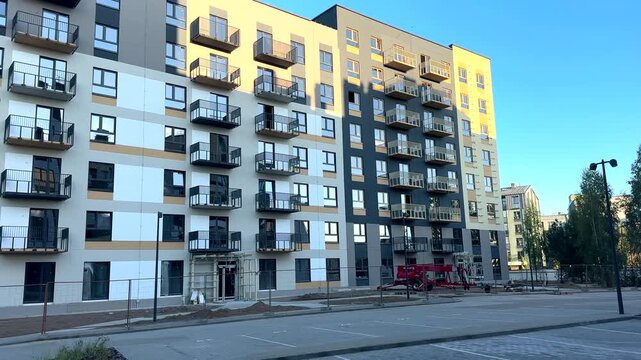 New residential condominium block under construction. Public housing development. New facade block building before painting. Building construction, renovation. Multifamily apartment condo construction