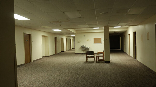 Empty eerie office hallway evoking a liminal space atmosphere