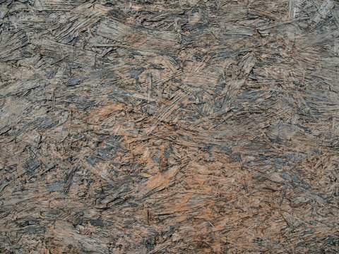 Close-up of weathered stone surface with rich texture. Earthy tones blend with subtle gray and brown hues. Natural patterns show erosion and age. Ideal for backgrounds, architectural design