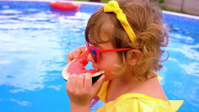 Children with watermelon near the pool. Selective focus. summer.