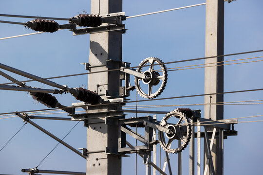 Railway overhead line mast with insulators and tension wheels