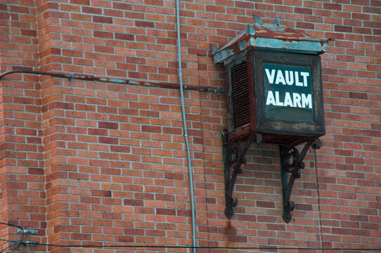 Old bank vault alarm on exterior of brick building