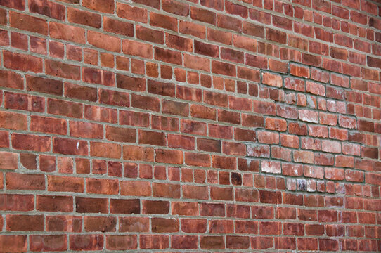 Old brick building wall with visible repair