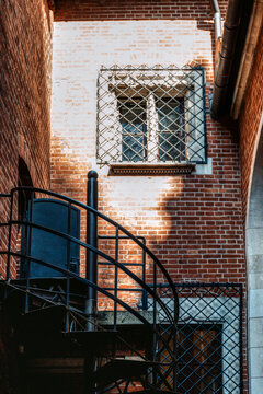 Spiral metal staircase and brick facade