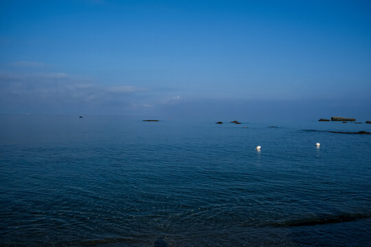 Calm blue sea at Citara Beach in Ischia, Italy. A peaceful, wide seascape view of the tranquil blue waters at Citara Beach on the island of Ischia. The calm Mediterranean Sea blends softly into the ho