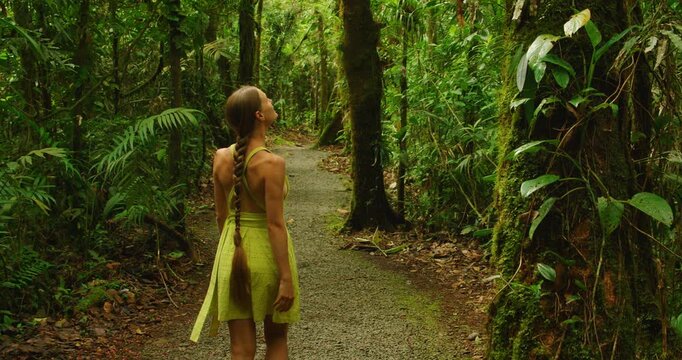 Tourist woman walking along a jungle trail in Costa Rica during a summer travel adventure