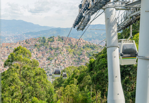 Metrocable cable car transporting people over medellin city
