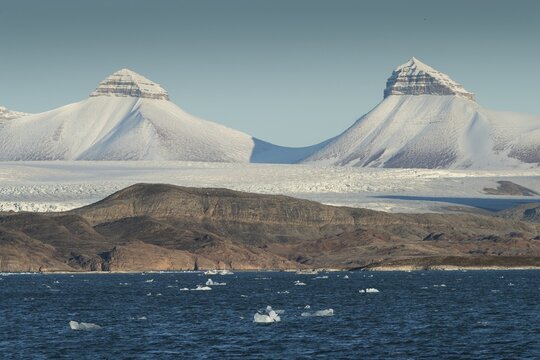 A fjord with ice floes and two of the three mountains: Tee Kroner (Three Crowns), Kronebreen or Kronengletscher Glacier, Kongsfjord or Kongsfjorden, the Svalbard archipelago, Svalbard, Norway