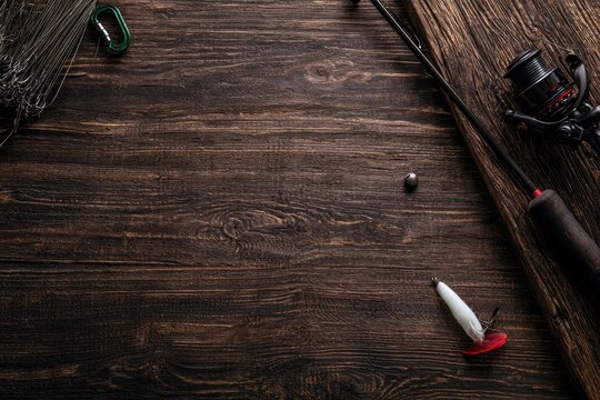 Fishing gear laid out on a rustic wooden surface