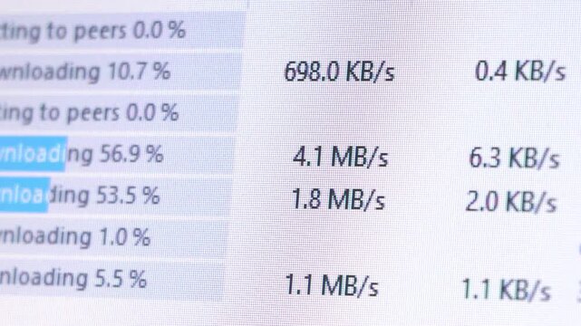 Close up of computer screen showing download progress bar with file transfer speed in megabytes per second. Internet data downloading technology concept