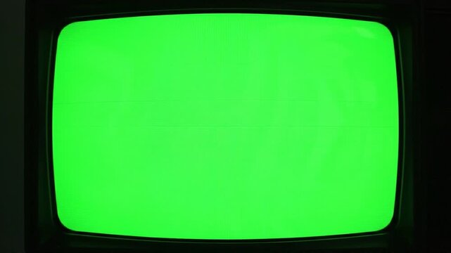 Retro vintage green screen television static broadcast monitor displaying digital noise interference with horizontal lines creating sense