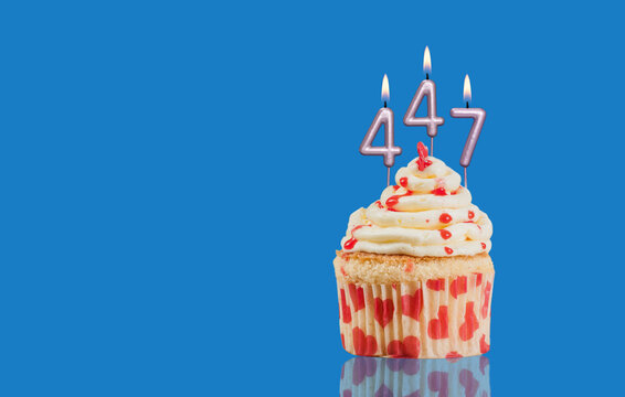 Birthday Or Anniversary Cupcake With Lit Candles; Candles Forming The Number 447
