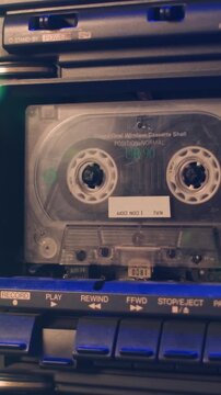 Cassette tape music player, Retro radio tape recorder, audio cassette close-up. Listening to music, old radio boom box player, macro of vintage music listening. 