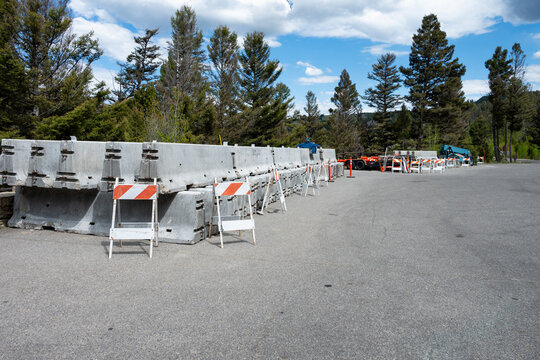Summer construction season work zone, concrete Jersey Barriers and traffic barriers in road pullout parking lot staging area, Yellowstone National Park
