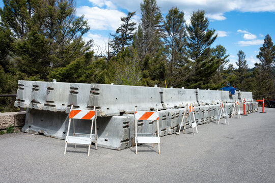 Summer construction season work zone, concrete Jersey Barriers and traffic barriers in road pullout parking lot staging area, Yellowstone National Park
