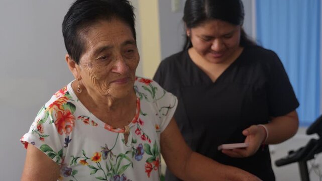 Elderly hispanic woman doing physical therapy on exercise bike