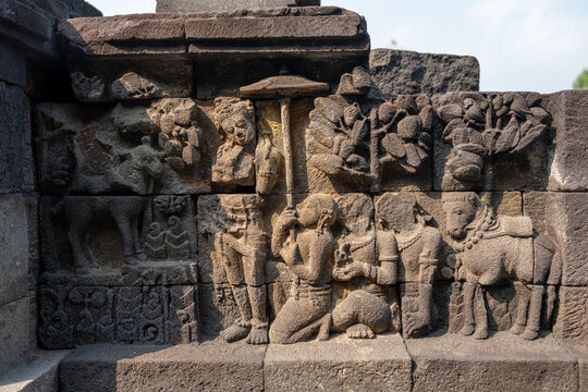 Borobudur temple stone relief carving depicting ancient figures