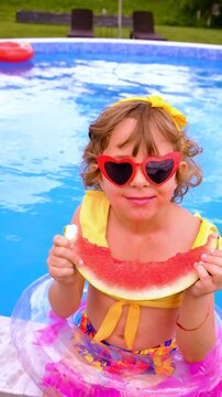 Children with watermelon near the pool. Selective focus. summer.