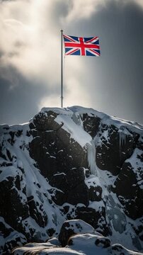 British flag flying on a snowy mountain peak representing summit success, patriotism, and winter exploration in the highlands