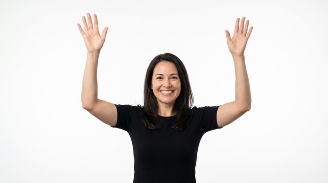 Happy smiling young woman raising both hands up in celebration or surrender against a white background