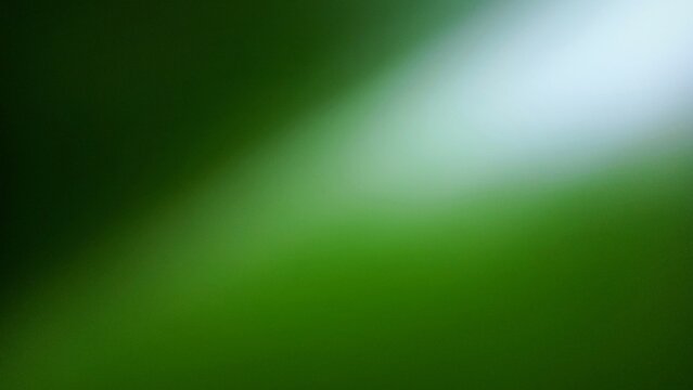Abstract green blurred background with bright light diagonal streak