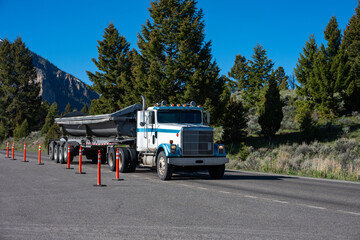 Summer construction season, side dumper truck on road, summer vacation at Yellowstone National Park  © knelson20