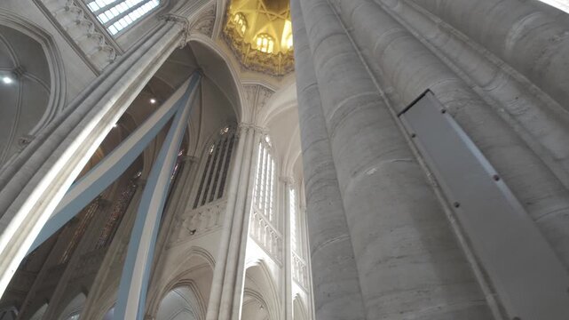 Downward shot revealing upper architectural vaults, columns and apse stained glass windows inside La Plata Cathedral, Buenos Aires Province, Argentina D-Log M.