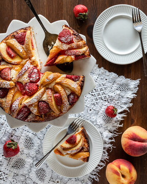 Above view of a delicious homemade strawberry peach cake with two servings. 