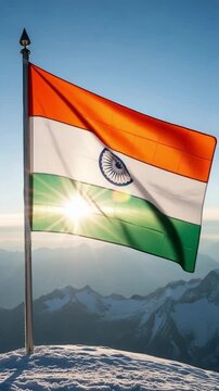 Indian national flag waving proudly on a snowy mountain peak at sunrise symbolizing patriotism freedom and national pride