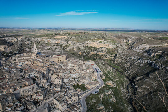 Aerial View of Matera's Sassi di Matera and Gravina di Matera Under Clear Blue Sky