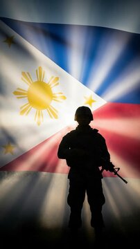 Filipino soldier silhouette standing proudly in front of the flag of the Philippines with bright sun rays representing patriotism and national defense