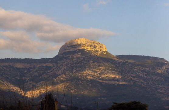 Iconic Garlaban Mountain in Provence. The distinct limestone summit of Garlaban mountain stands tall under the warm golden light of sunset.