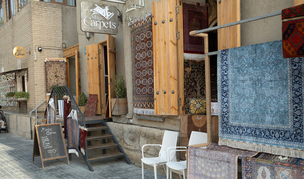 Bukhara, Uzbekistan &ndash; October 2, 2024: a cafe with rug at the historic Toki Telpak Furushon trading dome's exterior wall.