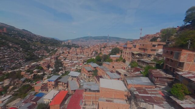 Metrocable gondola lift moving over medellin slums in colombia