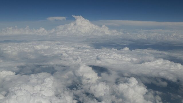 Cumulus Clouds Above a Vast Layer of Clouds