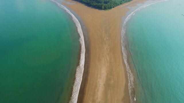 Wide aerial view of natural Whale Tail sand formation in tropical ocean waters at Marino Ballena National Park Costa Rica