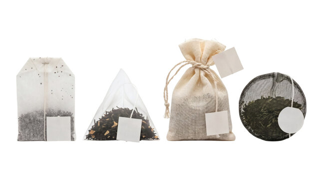 Collection of various tea bags with blank labels isolated on white background.
