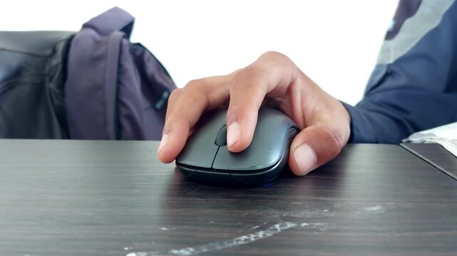male hand clicking on black computer mouse on work desk. Working with PC or laptop at work