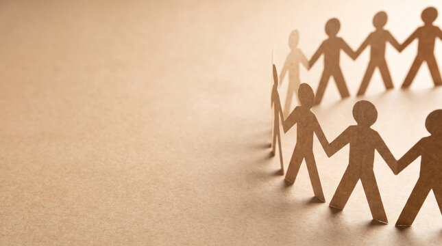 A circular chain of brown paper cutout people holding hands on a textured background representing unity teamwork community support and social connection in a minimalist artistic style