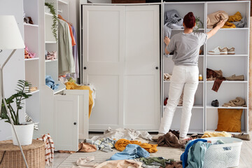 Naklejka premium Home organization and decluttering, woman tidying messy closet and sorting clothes in bedroom for minimalist lifestyle and sustainable living project