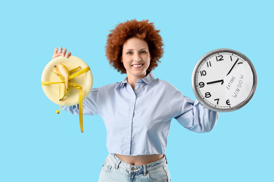 Intermittent fasting and weight loss, woman holding a banana on a plate with a measuring tape and a clock showing eating window on a blue background