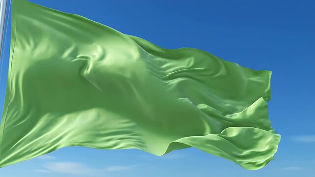 Green flag waving in the wind against a clear blue sky, fabric texture, smooth motion